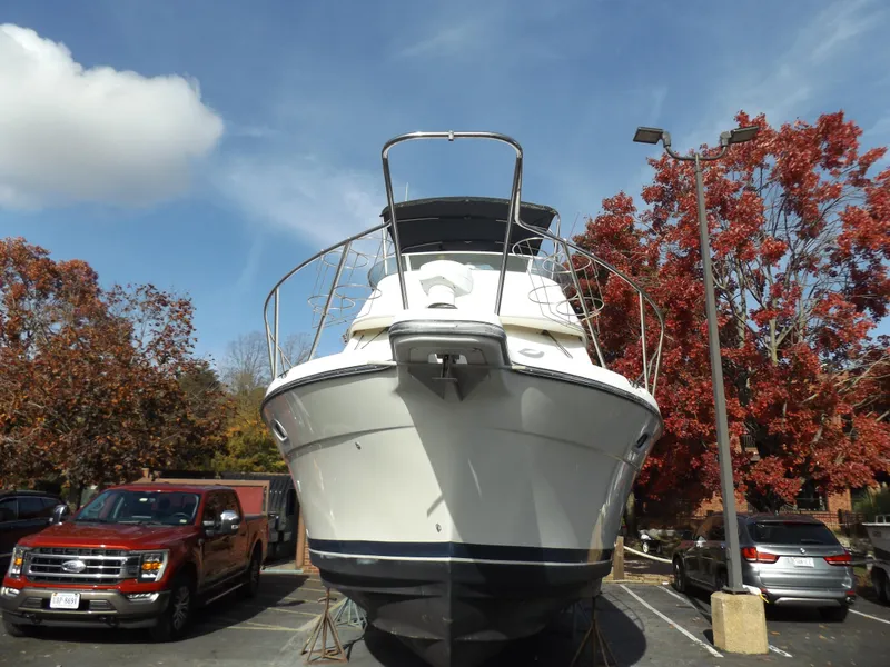 Slide: The Image of 2000 Bayliner 4087 Aft Cabin Motoryacht on trailer, surrounded by autumn trees. - 4