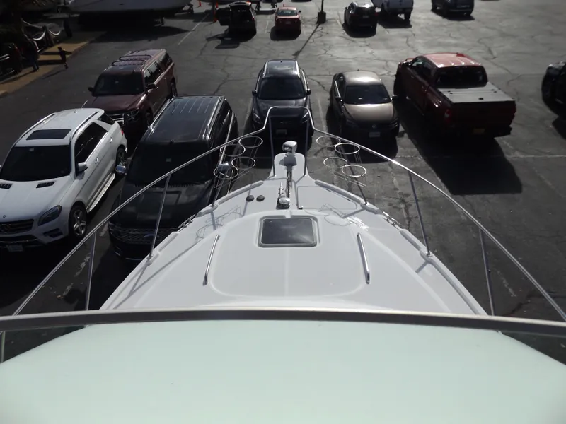 Slide: The Image of Bayliner 4087 Aft Cabin Motoryacht 2000, parked among cars in a lot. - 5