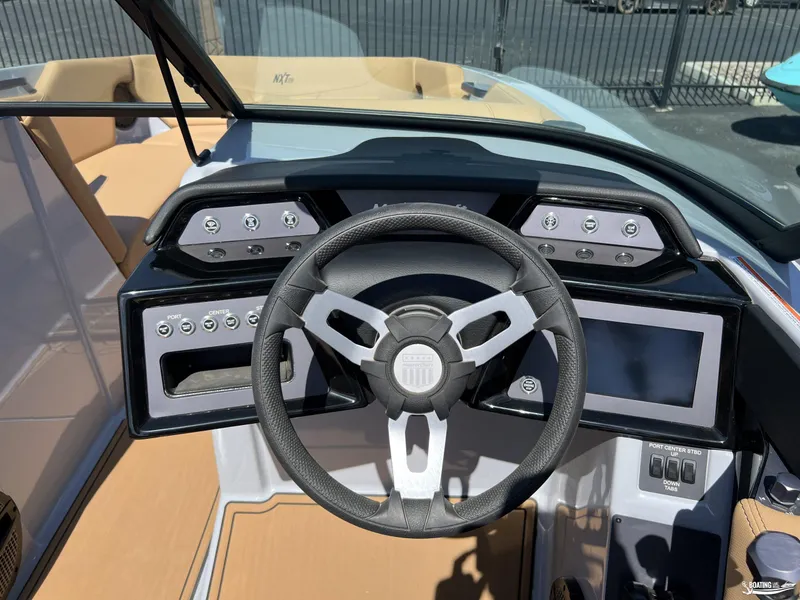 Slide: The Image of 2025 MasterCraft NXT24 boat dashboard with steering wheel and control panel. - 10