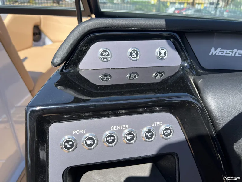 Slide: The Image of Control panel of 2025 MasterCraft NXT24 boat with ballast and engine switches. - 11