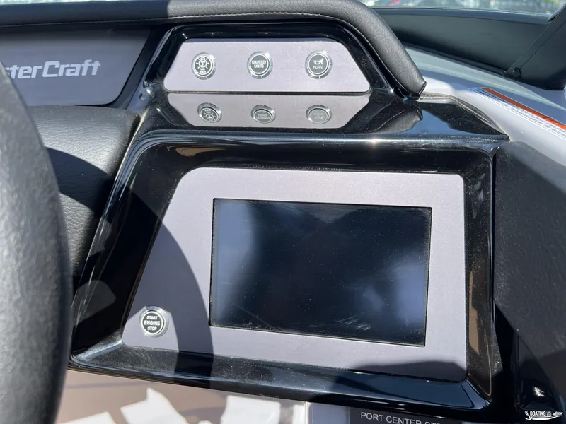 Slide: The Image of Dashboard of 2025 MasterCraft NXT24 boat with touchscreen and control buttons. - 12