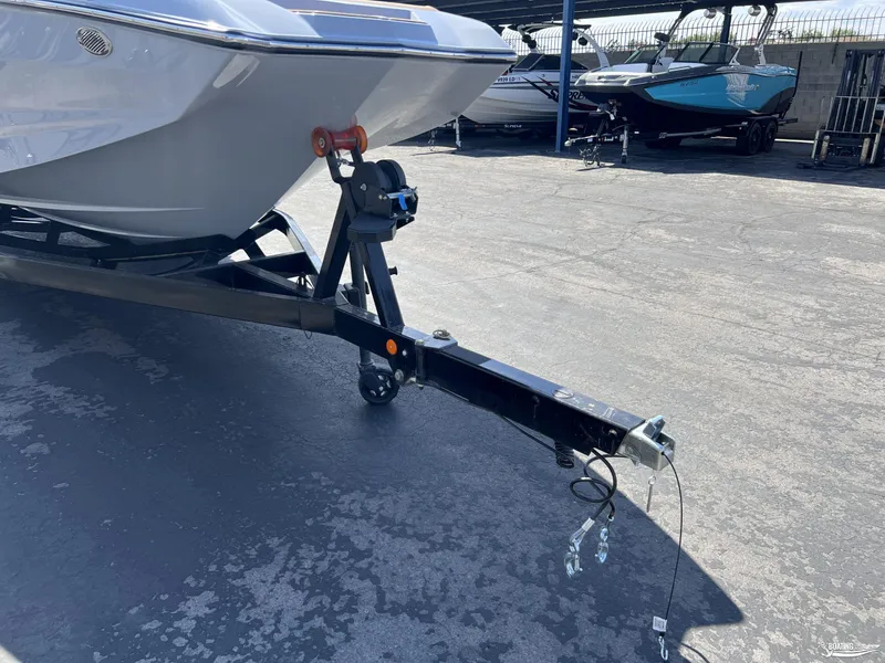 Slide: The Image of 2025 MasterCraft NXT24 boat on trailer in parking lot. - 20