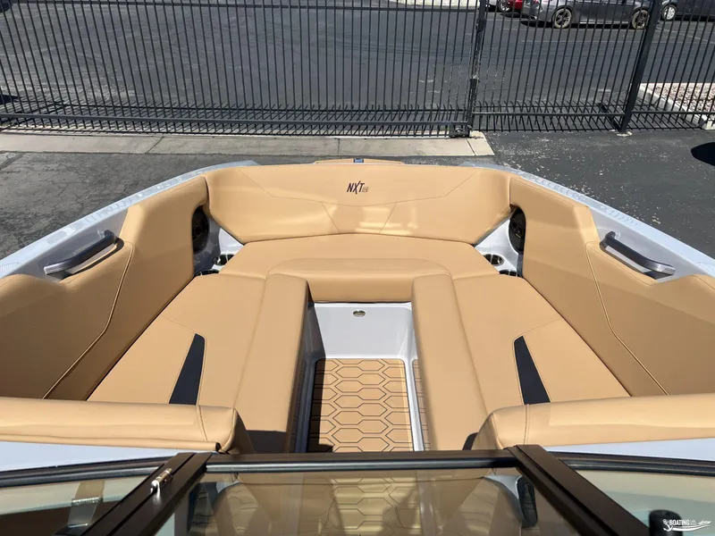 Slide: The Image of 2025 MasterCraft NXT24 boat interior with tan seating and modern design. - 5