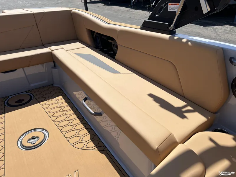 Slide: The Image of 2025 MasterCraft NXT24 boat interior with beige seating and patterned flooring. - 8