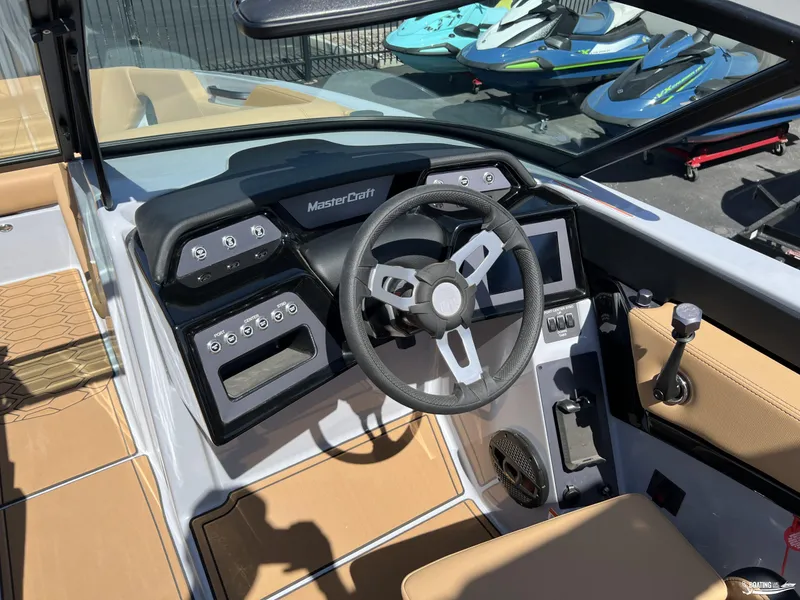 Slide: The Image of 2025 MasterCraft NXT24 boat dashboard with steering wheel and control panel. - 9