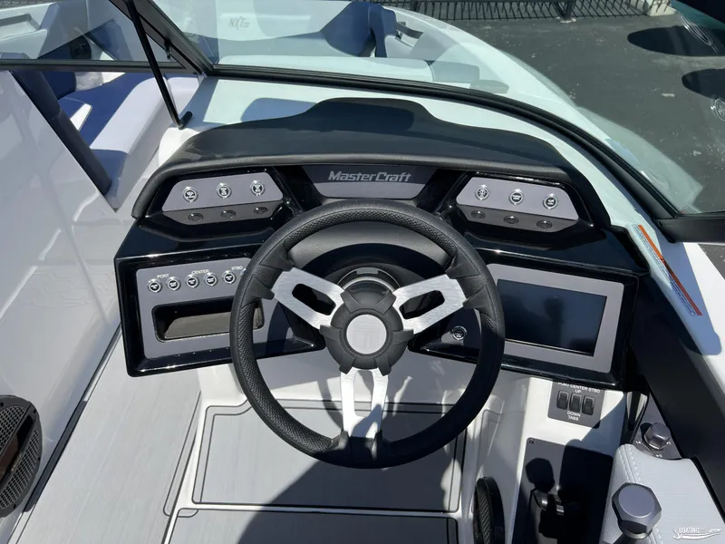 Slide: The Image of 2025 MasterCraft NXT22 dashboard with steering wheel and control panel. - 10
