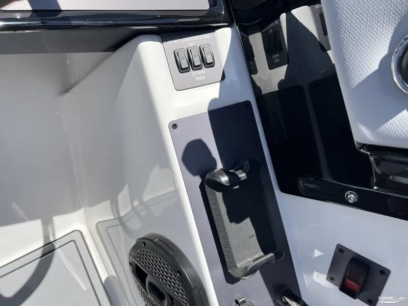 Slide: The Image of Control panel of 2025 MasterCraft NXT22 boat with speaker and switches. - 13