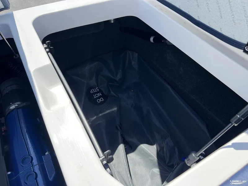 Slide: The Image of Open storage compartment in 2025 MasterCraft NXT22 boat, labeled "Do Not Step." - 17