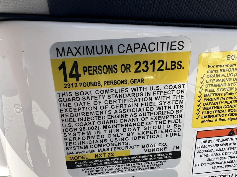 Slide: The Image of 2025 MasterCraft NXT22 capacity label: 14 persons or 2312 lbs, U.S. Coast Guard compliant. - 21