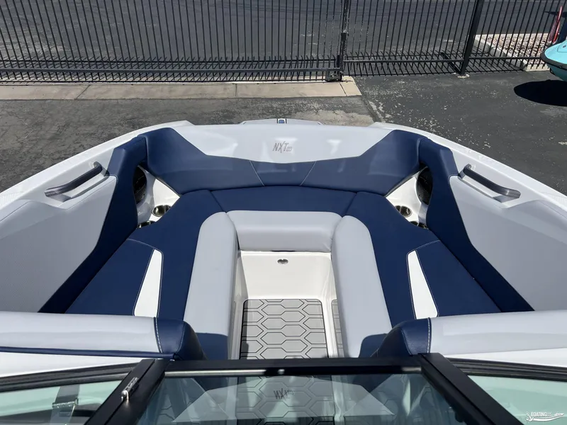 Slide: The Image of 2025 MasterCraft NXT22 boat interior with blue and white seating, modern design. - 5