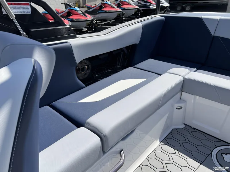 Slide: The Image of 2025 MasterCraft NXT22 boat interior with blue and gray seating, showcasing modern design. - 6