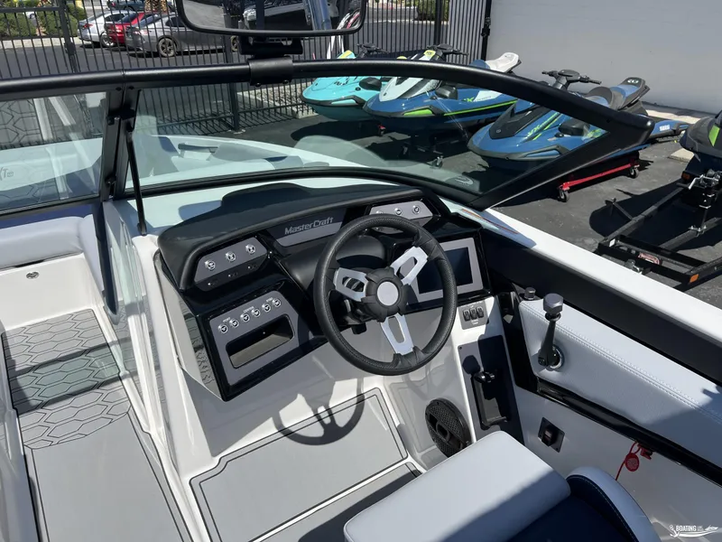 Slide: The Image of 2025 MasterCraft NXT22 boat cockpit with modern steering and control panel. - 9