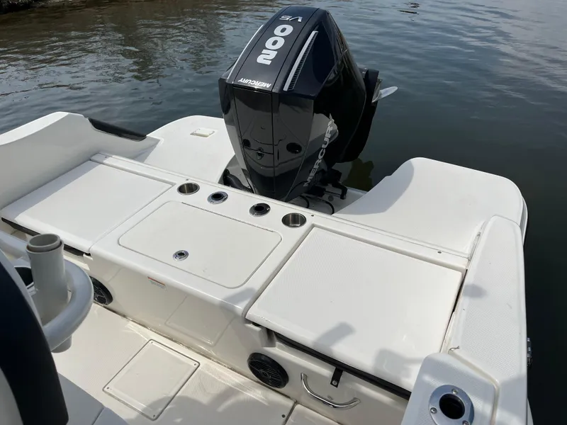 Slide: The Image of 2023 Bayliner Trophy T22CC boat with powerful outboard motor on calm water. - 3