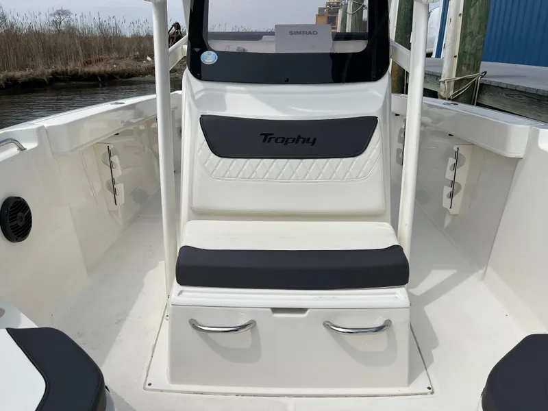 Slide: The Image of 2023 Bayliner Trophy T22CC boat interior with seating and storage compartments. - 6