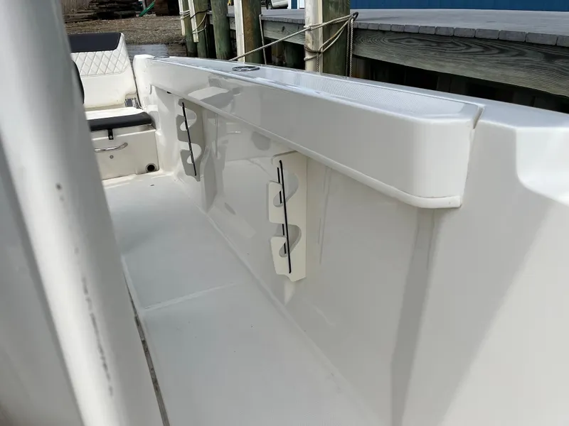 Slide: The Image of 2023 Bayliner Trophy T22CC boat interior, showcasing sleek white design and seating area. - 7