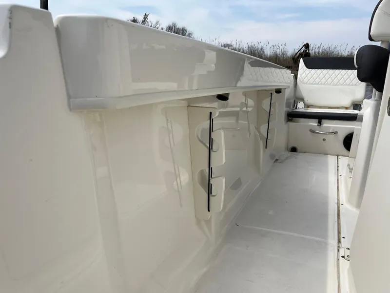 Slide: The Image of 2023 Bayliner Trophy T22CC boat interior with storage compartments and seating. - 8