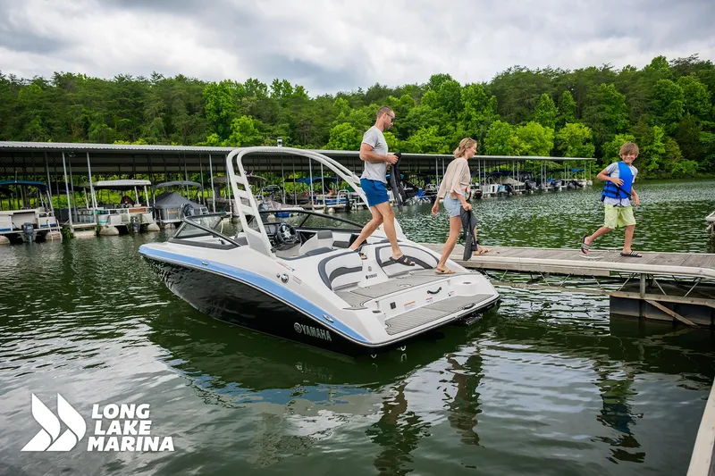Slide: The Image of 2025 Yamaha Boats 195S at Long Lake Marina with family boarding. - 5