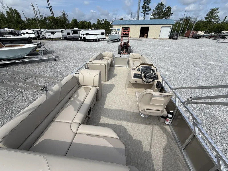 Slide: The Image of 2025 Avalon Venture 21 CRUISE pontoon boat with spacious seating, parked in a lot. - 5