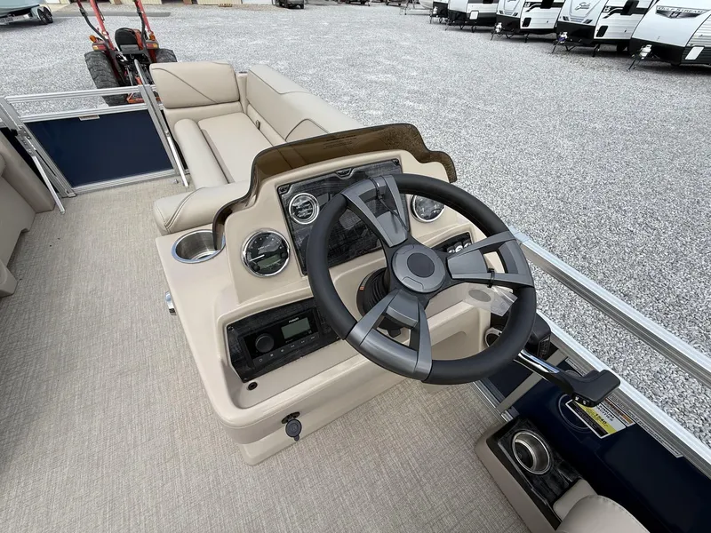 Slide: The Image of 2025 Avalon VENTURE 23 QUAD LOUNGER boat interior with steering wheel and seating. - 6