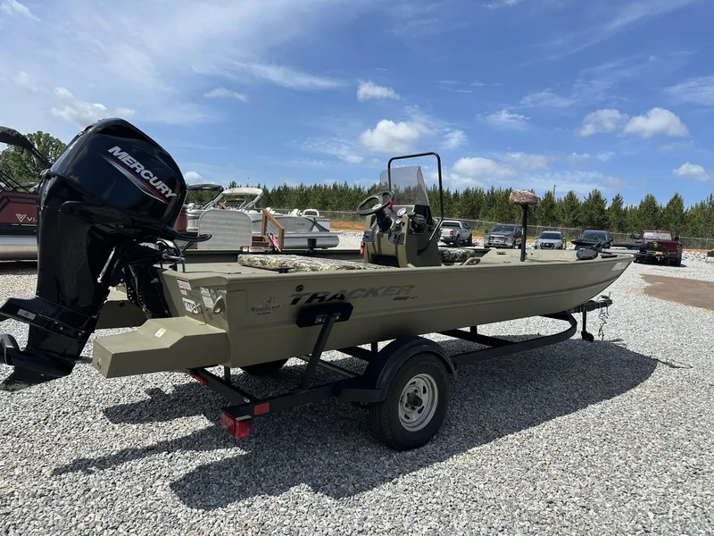 Slide: The Image of 2024 Tracker Grizzly 1860 CC boat with Mercury engine on trailer, parked outdoors. - 8