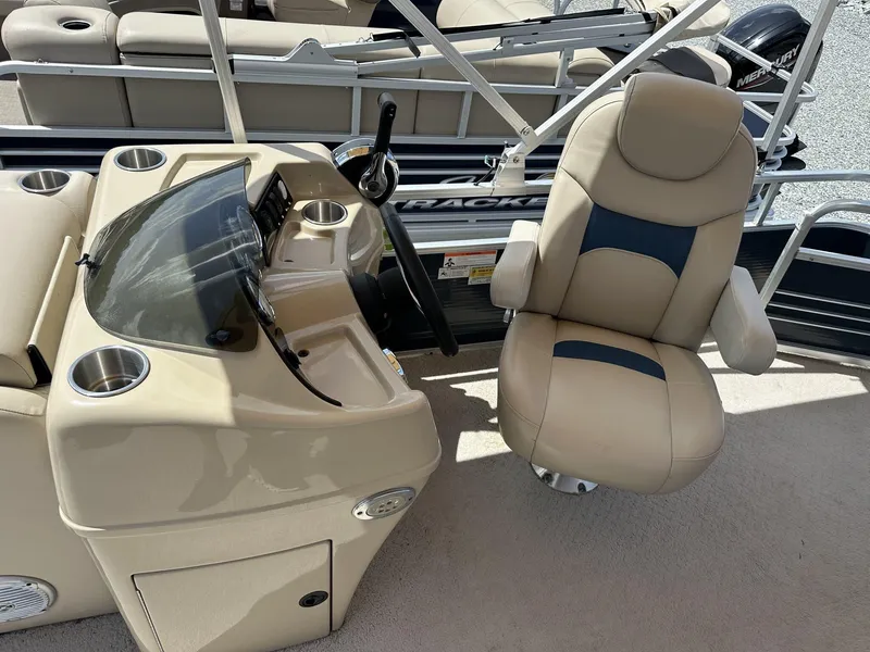 Slide: The Image of Captain's chair and console of 2015 Lowe SS190 boat, featuring beige upholstery and steering controls. - 10