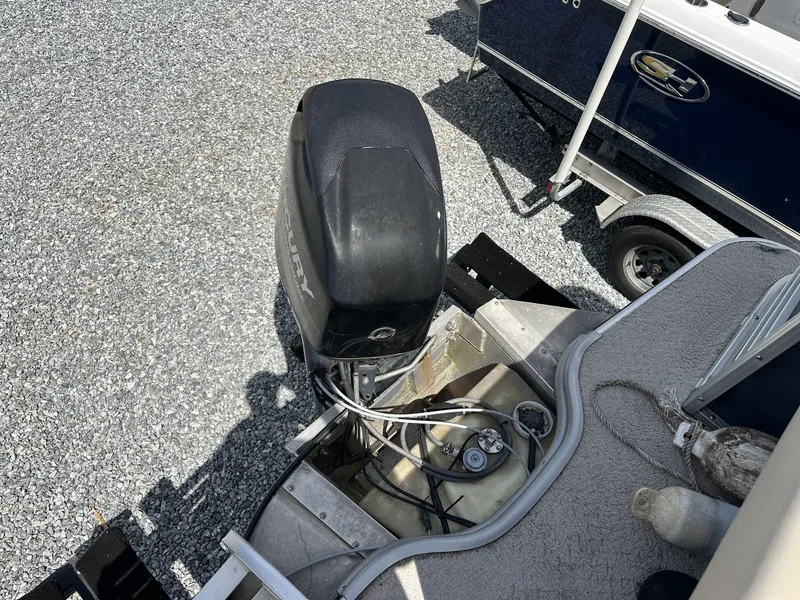 Slide: The Image of 2015 Lowe SS190 boat with Mercury outboard motor on gravel surface. - 12