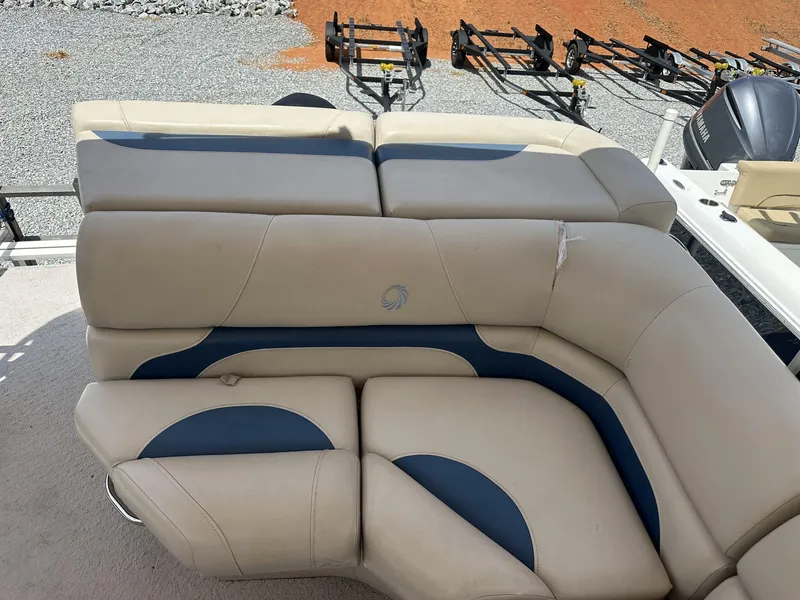 Slide: The Image of 2015 Lowe SS190 boat seating with beige and blue upholstery, parked on gravel. - 4