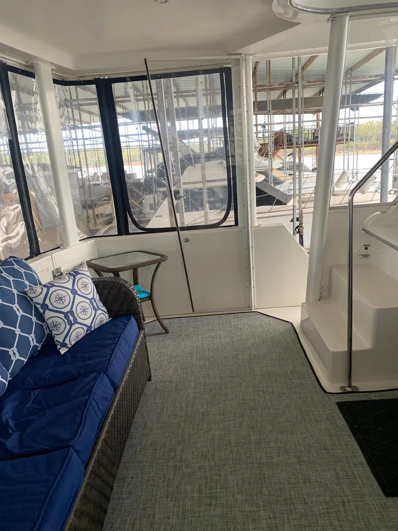 Slide: The Image of 1994 Carver 440 Aft Cabin Motor Yacht interior with blue seating and large windows. - 16