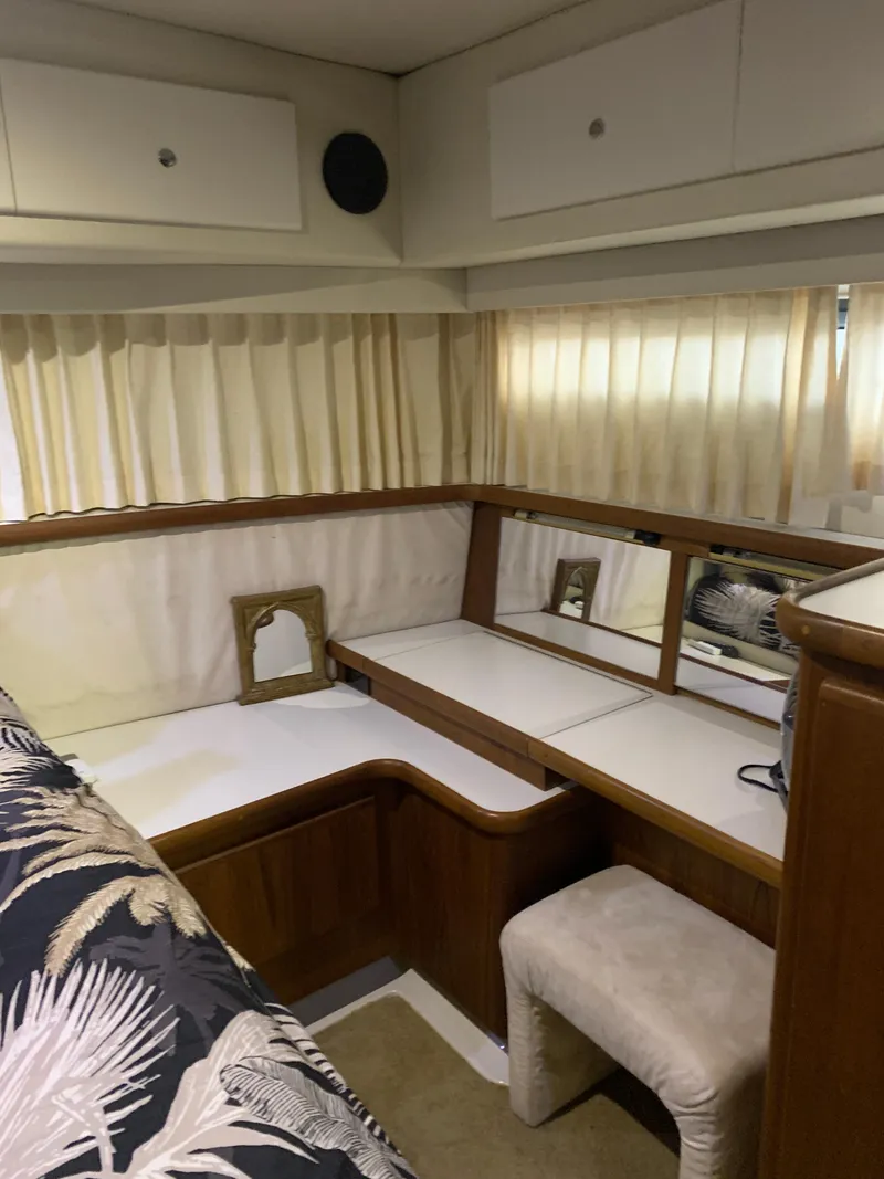Slide: The Image of 1994 Carver 440 Aft Cabin Motor Yacht interior with covered seating and carpeted flooring. - 20