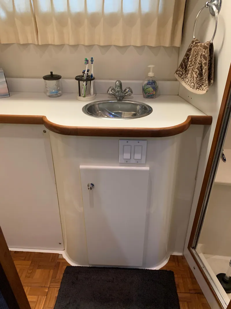 Slide: The Image of 1994 Carver 440 Aft Cabin Motor Yacht bathroom with sink, faucet, and accessories. - 25
