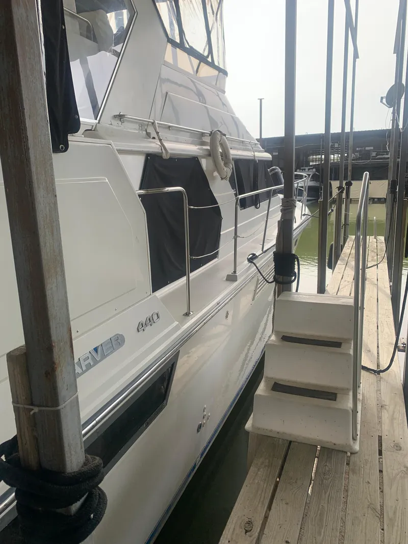 Slide: The Image of 1994 Carver 440 Aft Cabin Motor Yacht docked with boarding steps. - 3