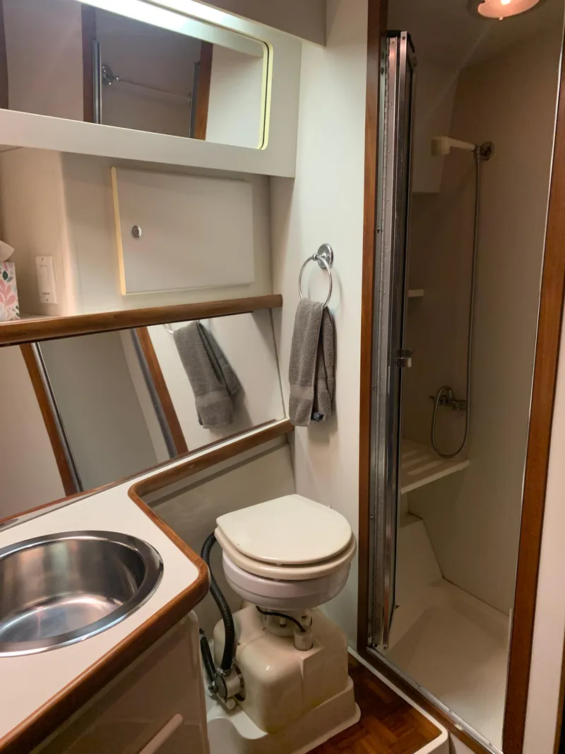 Slide: The Image of 1994 Carver 440 Aft Cabin Motor Yacht bathroom with shower, sink, and toilet. - 39