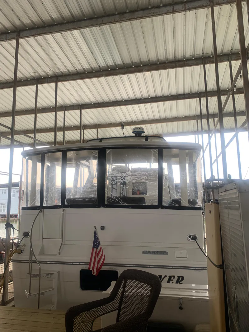 Slide: The Image of 1994 Carver 440 Aft Cabin Motor Yacht interior with kitchen and seating area. - 4