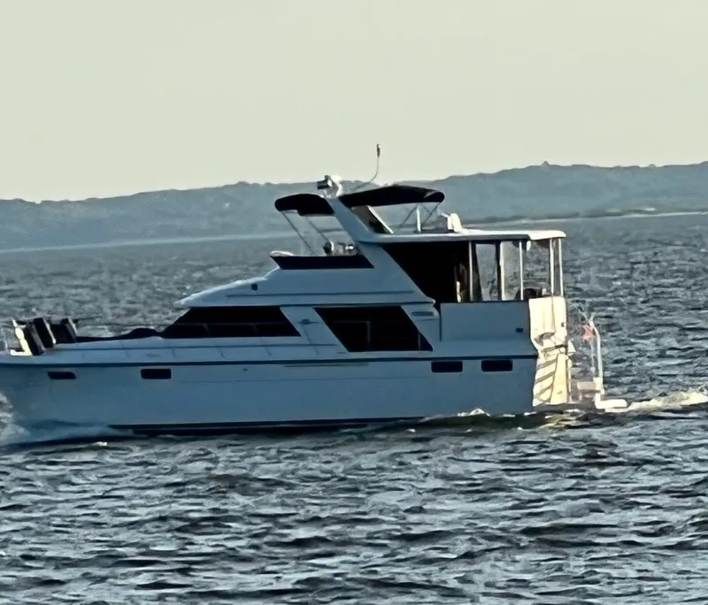 Slide: The Image of 1994 Carver 440 Aft Cabin Motor Yacht cruising on open water. - 41
