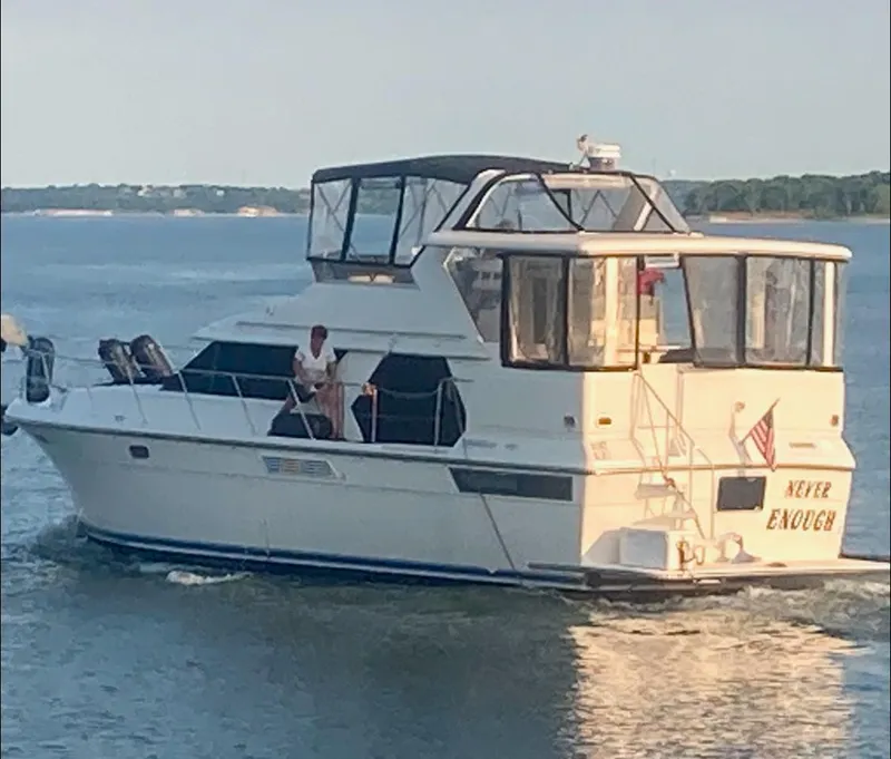 Slide: The Image of 1994 Carver 440 Aft Cabin Motor Yacht cruising on a calm lake. - 42