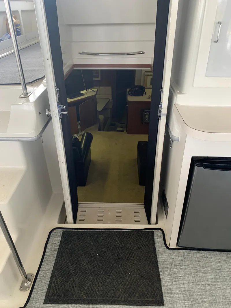 Slide: The Image of Interior of 1994 Carver 440 Aft Cabin Motor Yacht with mirrored closet and tropical bedding. - 9