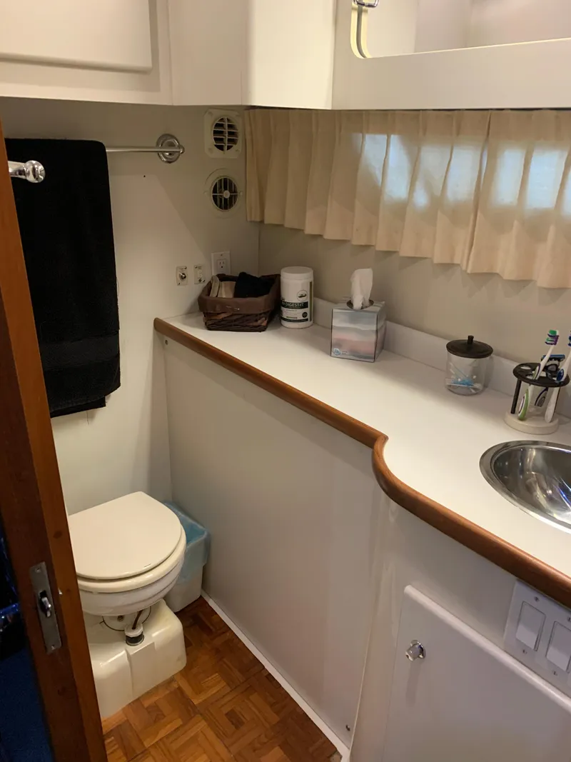 Slide: The Image of Interior of 1994 Carver 440 Aft Cabin Motor Yacht with mirrored closet and tropical bedding. - 24