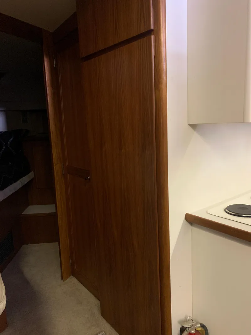 Slide: The Image of 1994 Carver 440 Aft Cabin Motor Yacht interior with beige sofa and dark cushions. - 33