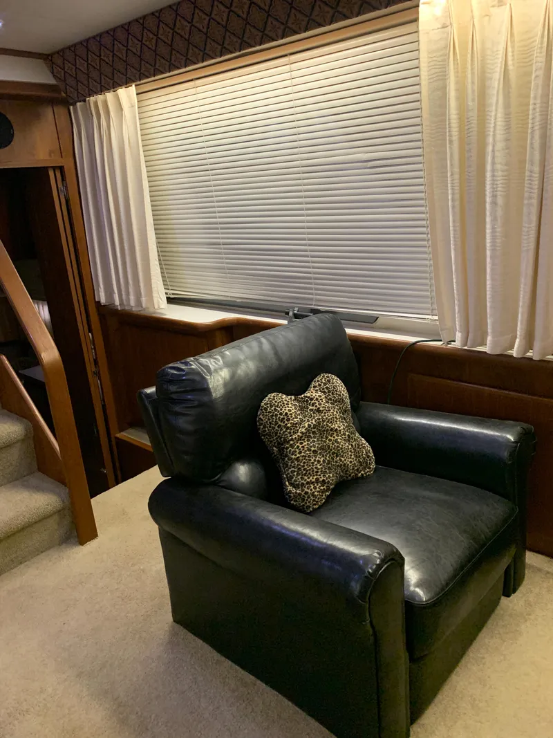 Slide: The Image of 1994 Carver 440 Aft Cabin Yacht interior with leather chair and decorative pillow. - 47
