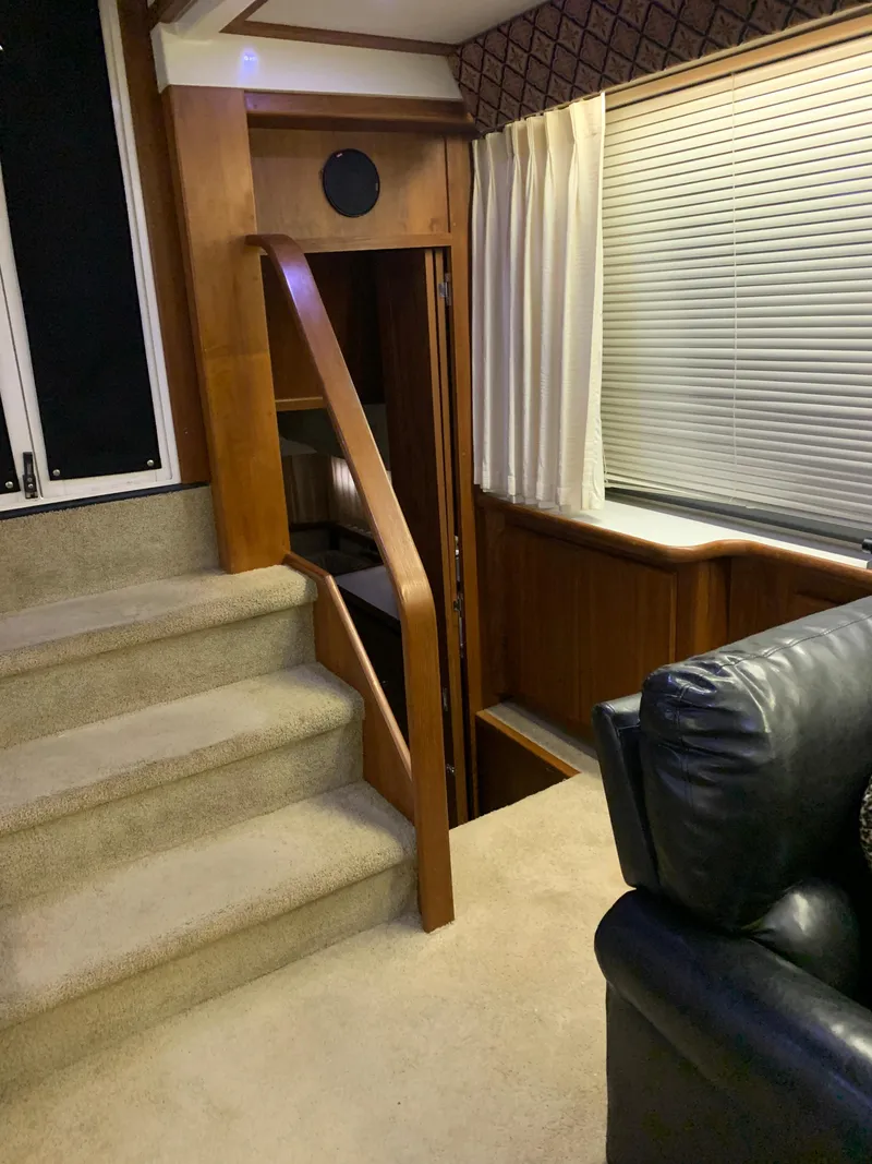 Slide: The Image of Interior of 1994 Carver 440 Aft Cabin Motor Yacht with stairs and seating area. - 49