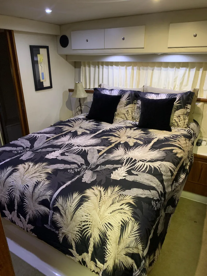 Slide: The Image of 1994 Carver 440 Aft Cabin Motor Yacht bedroom with tropical bedding and modern decor. - 50