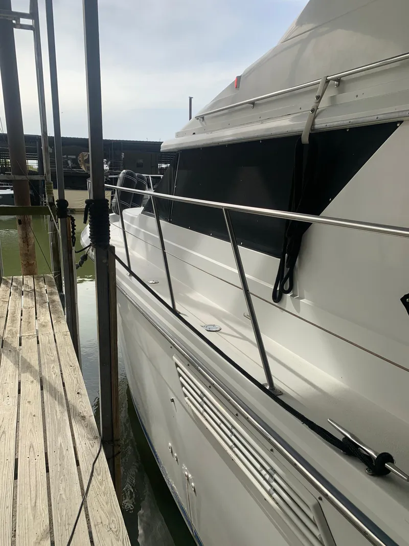Slide: The Image of 1994 Carver 440 Aft Cabin Motor Yacht docked with boarding steps. - 6