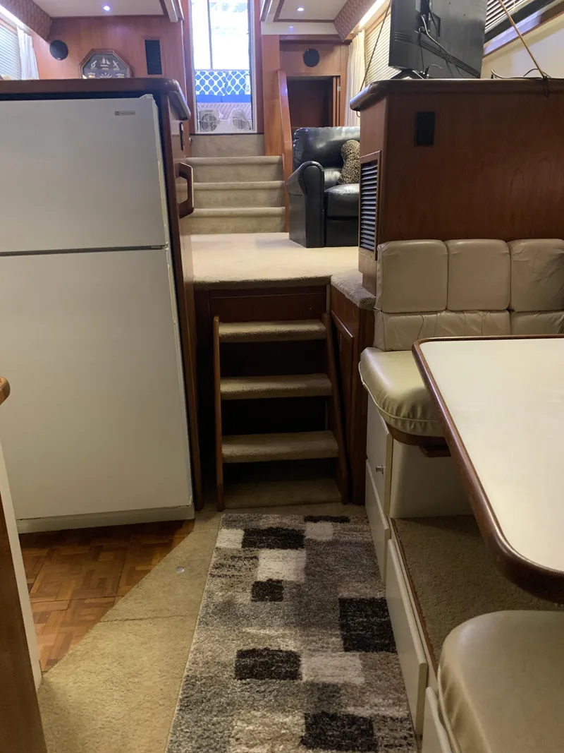 Slide: The Image of Interior of 1994 Carver 440 Aft Cabin Motor Yacht with cozy seating and kitchen area. - 63