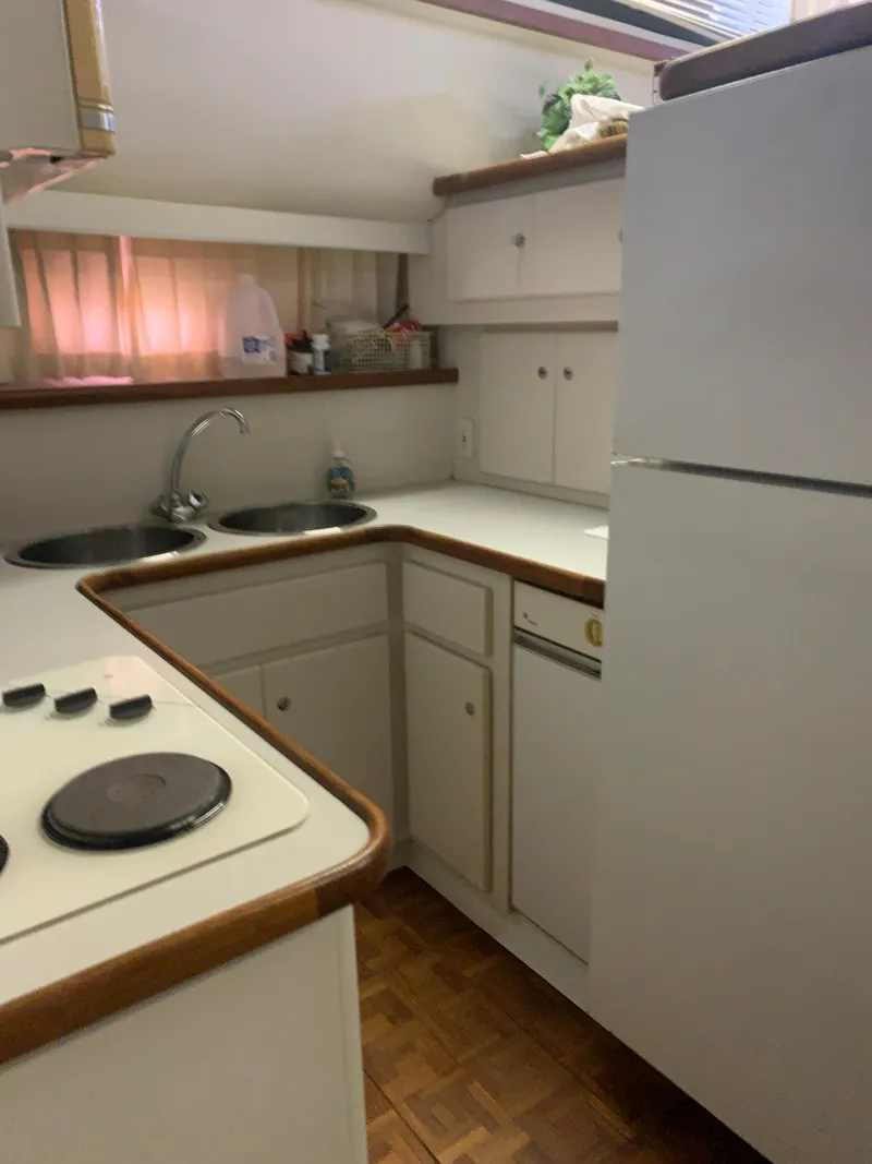 Slide: The Image of Compact kitchen in a 1994 Carver 440 Aft Cabin Motor Yacht with modern amenities. - 66