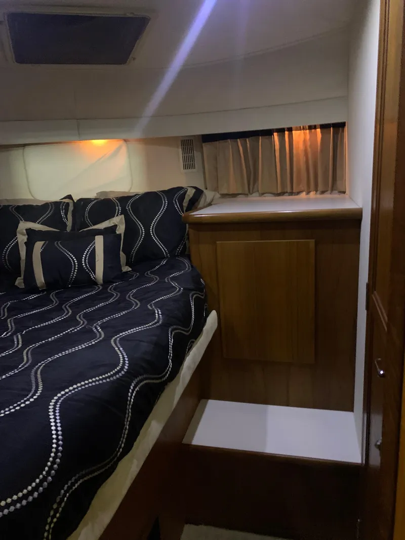 Slide: The Image of 1994 Carver 440 Aft Cabin Motor Yacht bedroom with elegant bedding and wood accents. - 72