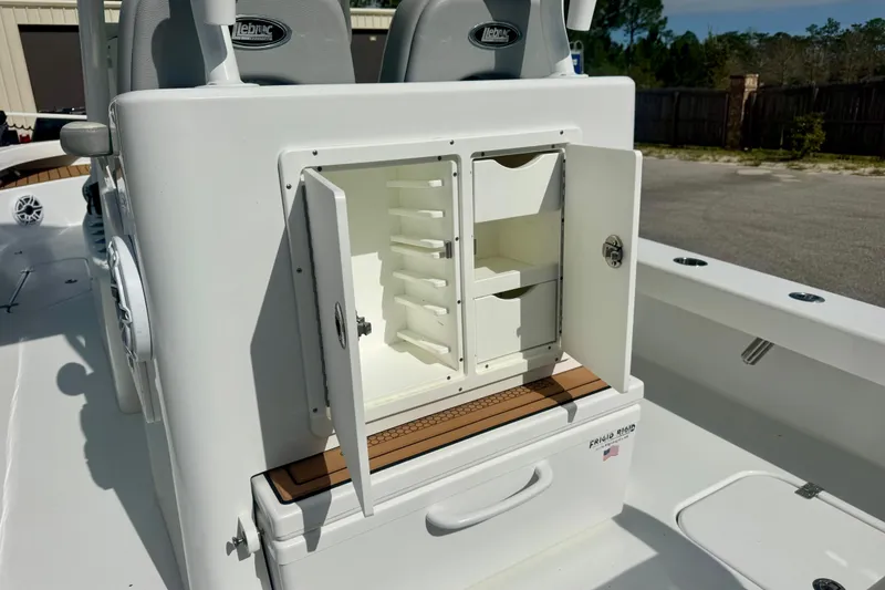 Slide: The Image of Open storage compartment on 2023 ZCB Freemason 26 boat, featuring organized shelves. - 12