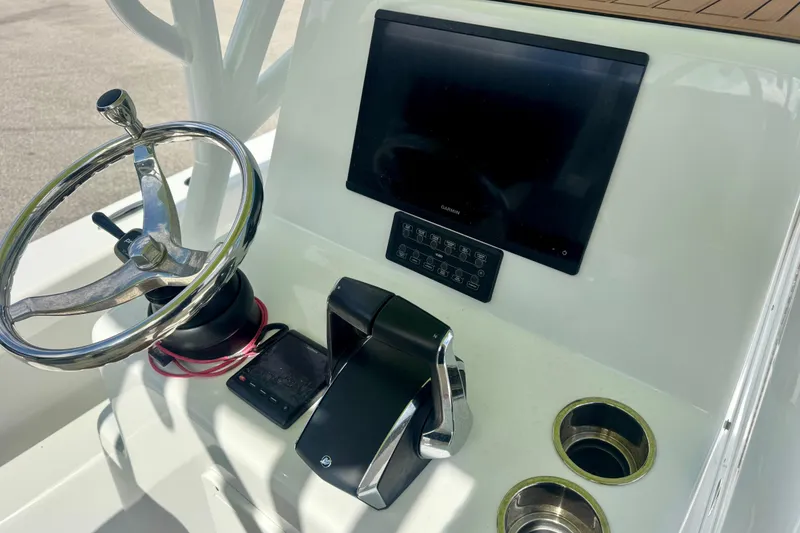 Slide: The Image of Control panel of 2023 ZCB Freemason 26 boat with steering wheel and touchscreen display. - 13