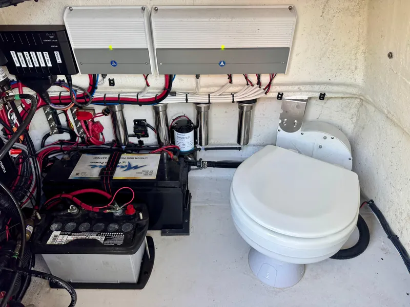 Slide: The Image of Battery and wiring setup next to a toilet in a ZCB Freemason 26, 2023 model. - 5