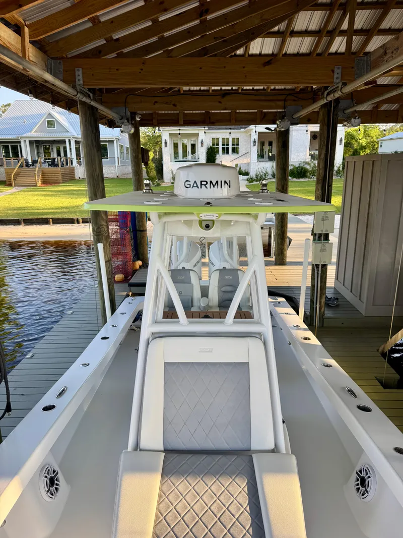 Slide: The Image of 2023 ZCB Freemason 26 boat docked under a wooden shelter with Garmin equipment. - 6
