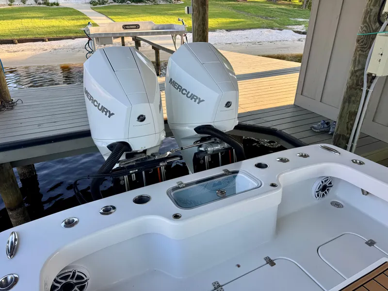Slide: The Image of Twin Mercury outboard engines on a 2023 ZCB Freemason 26 boat at a dock. - 9